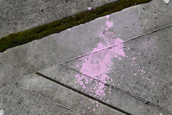 Pink splatter on the sidewalk.